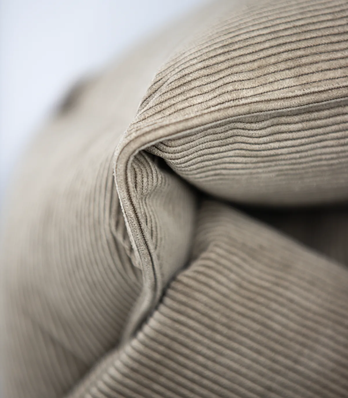 Détail du velours côtelé beige du panier pour chien.